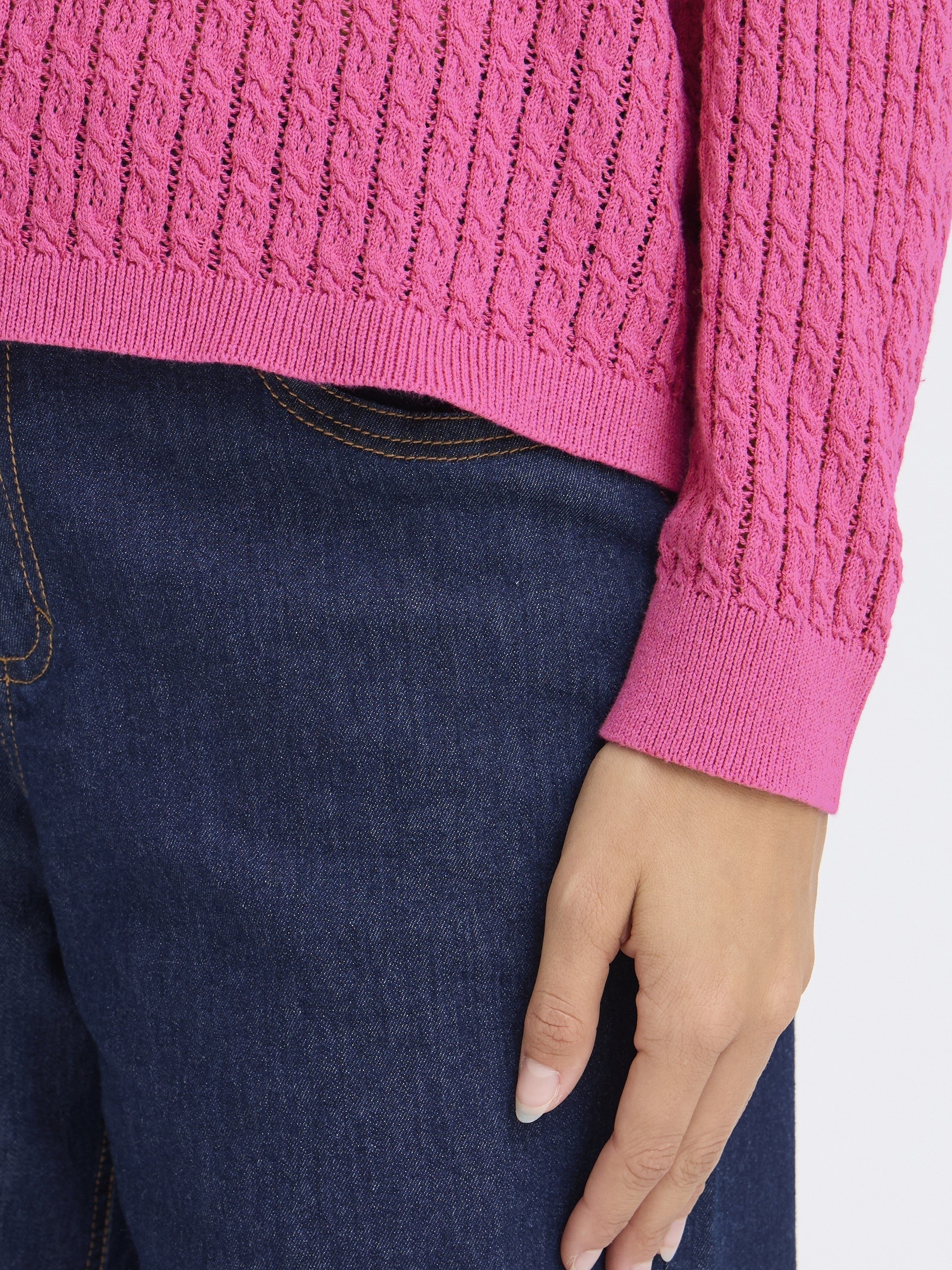 Fransa Sammy Mini Cable Knit Crew Neck Sweater in berry pink knit detail with dark denim jeans and hand visible