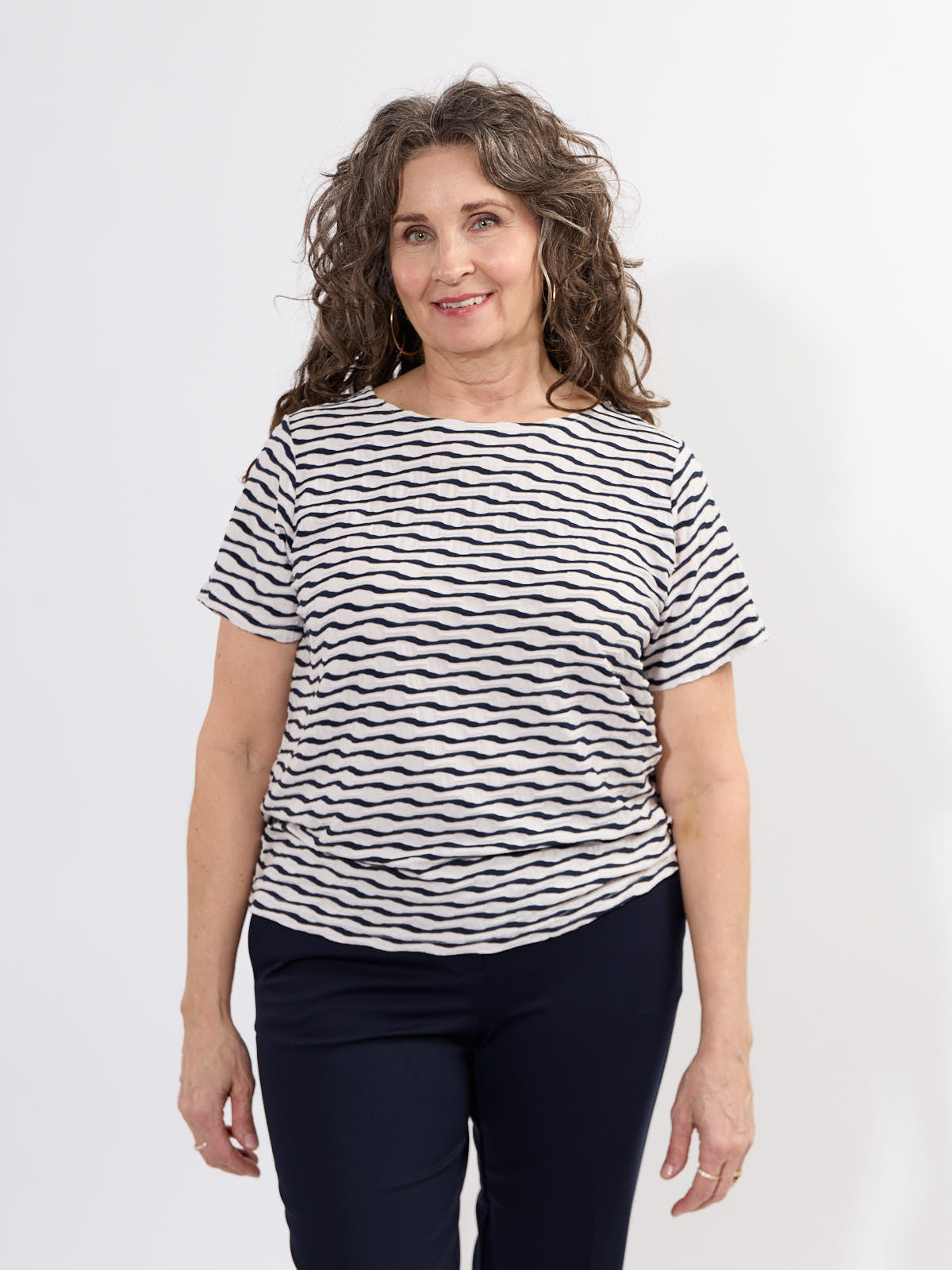 Fransa Niamy Textured Wave Short Sleeve Top in navy and white waves, styled with dark pants by Fransa.