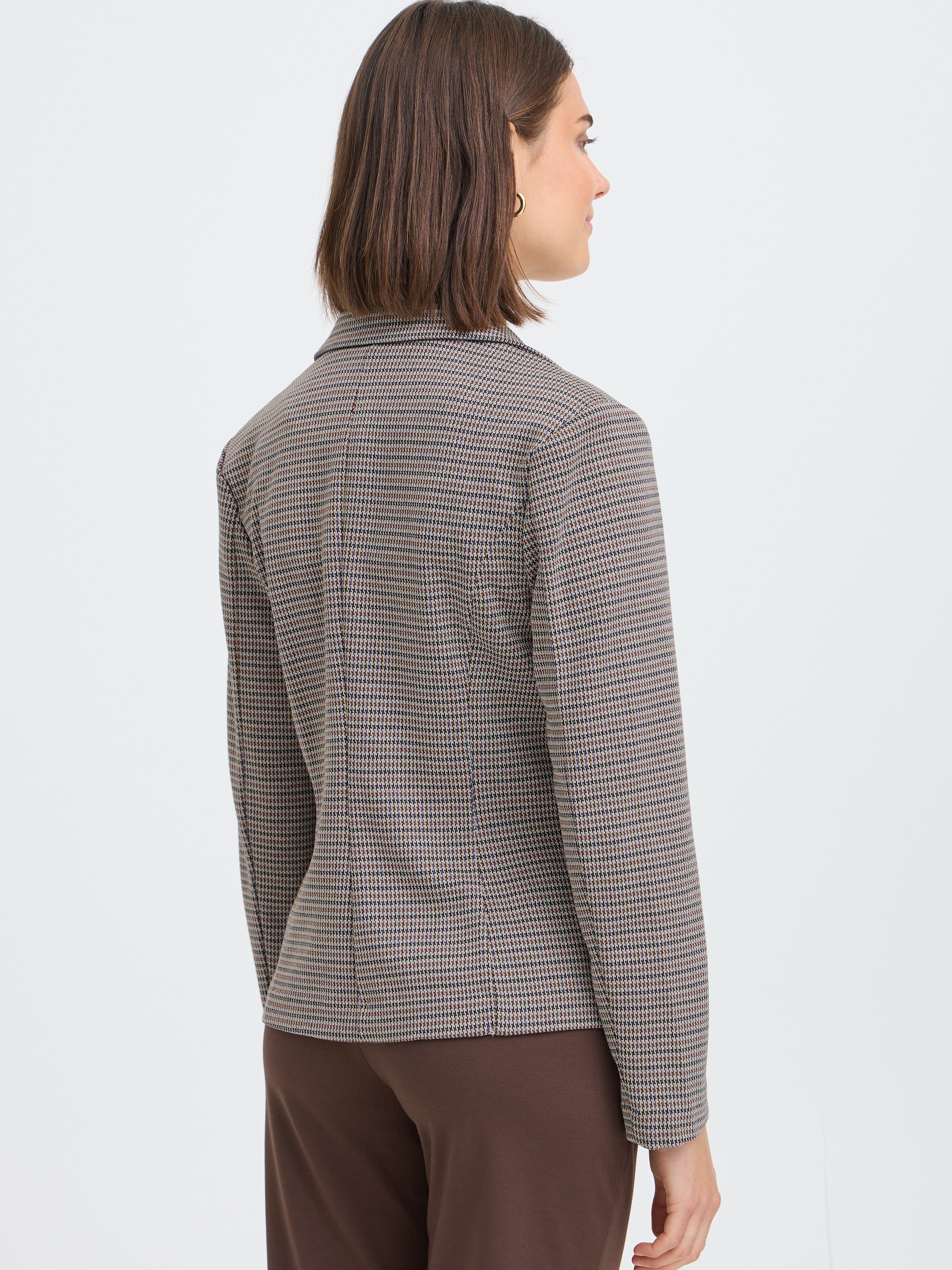 Back view of a tailored checked blazer paired with brown pants against a plain light background.