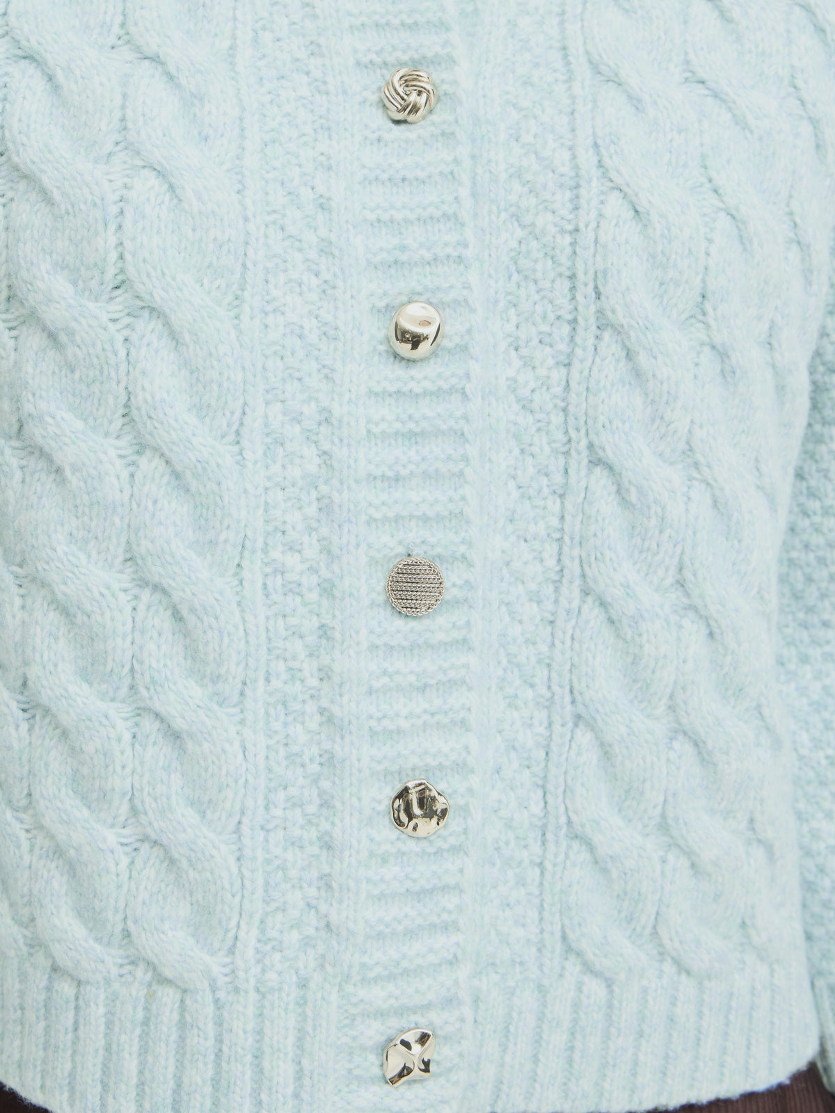 Light blue cable-knit sweater with a ribbed front placket and five decorative buttons