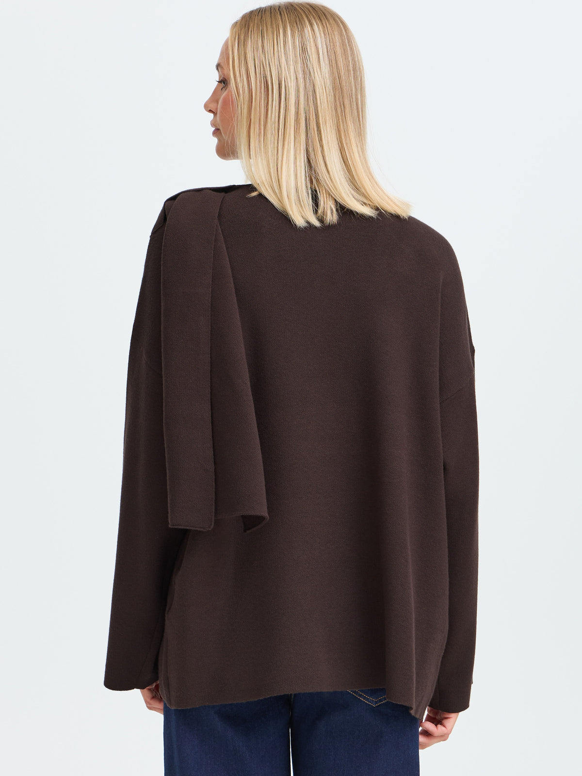 Back view of a dark brown jacket with long sleeves and a relaxed fit