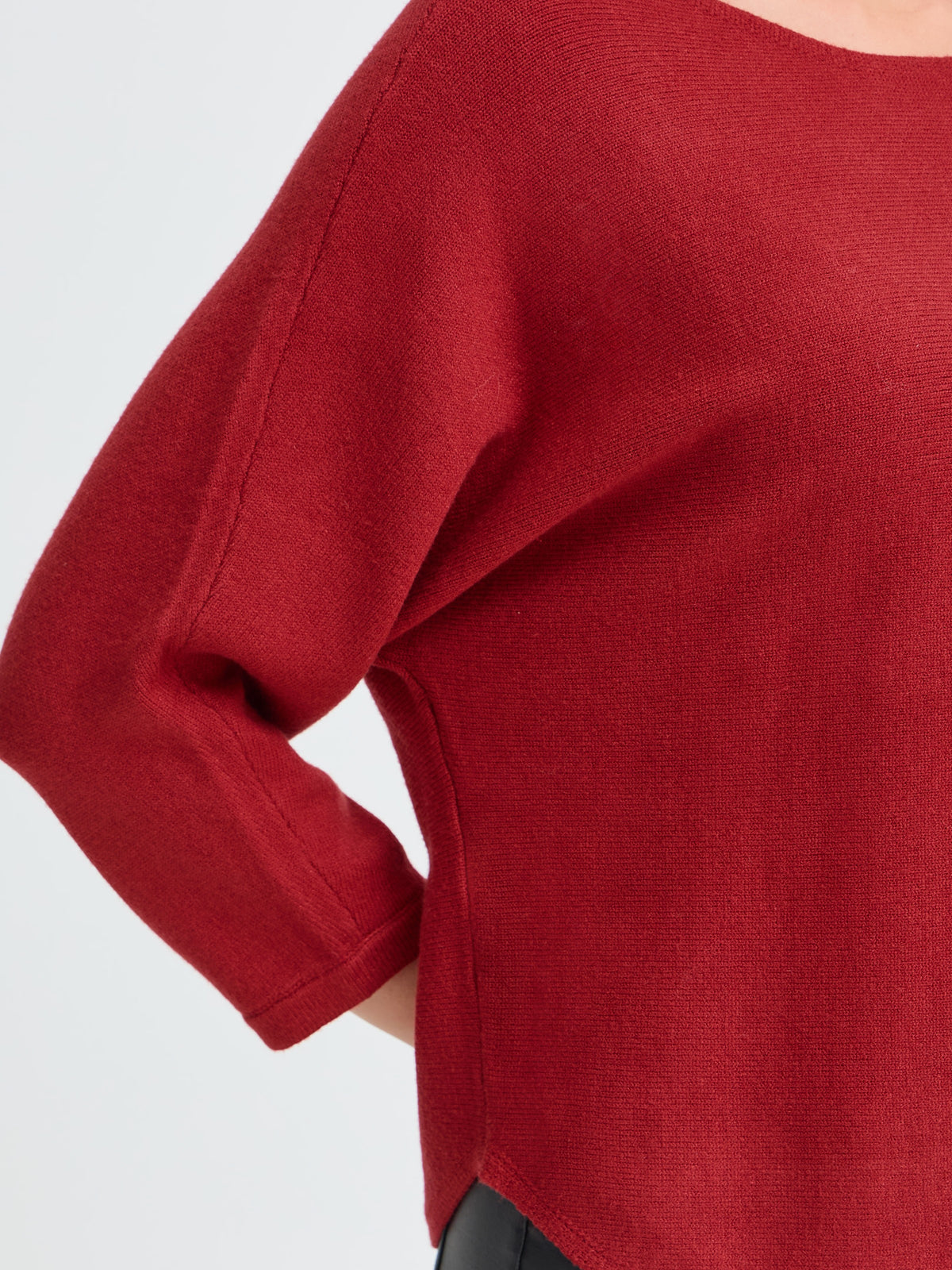 Red long-sleeve sweater with a relaxed fit and side slit hem