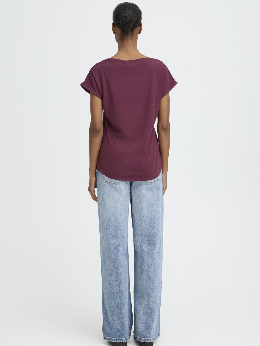B. Young Pamila Basic T-Shirt in burgundy by B. Young, paired with light blue denim jeans from the back view.