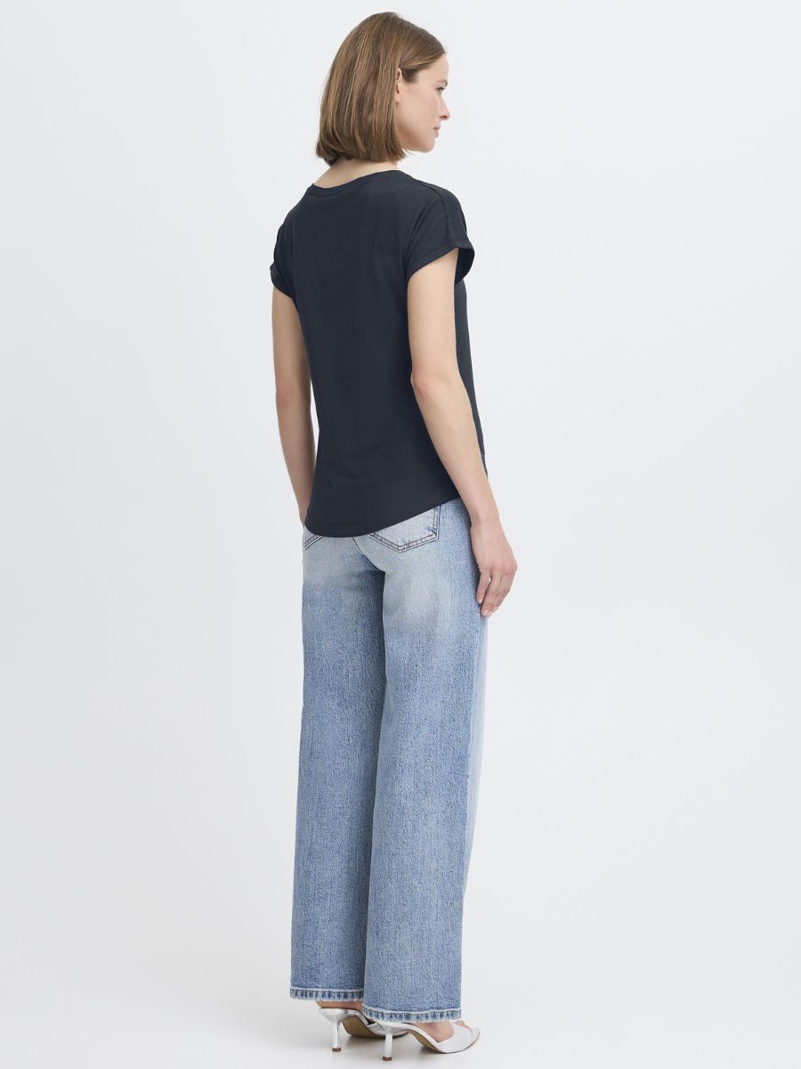 Back view of a model wearing B. Young Pamila Basic Tee in navy with light washed denim jeans from B. Young.