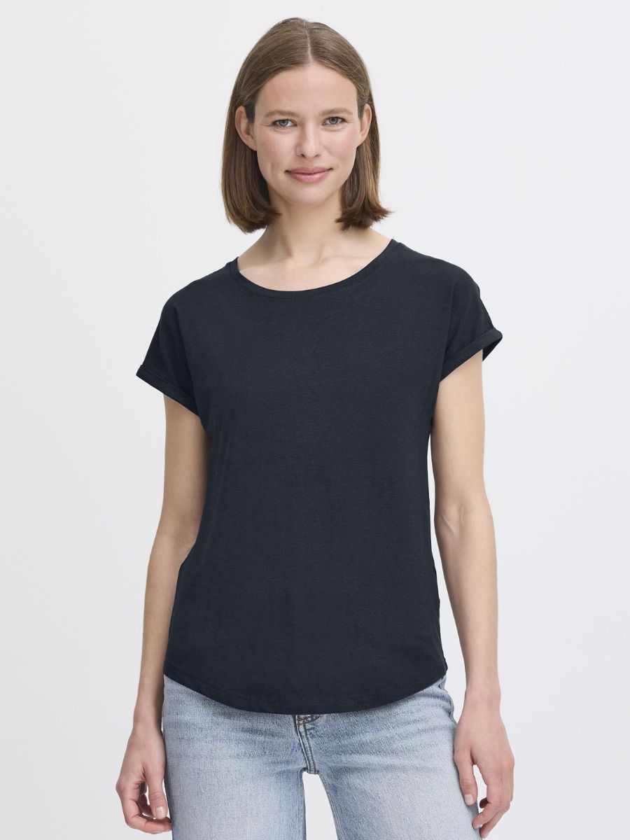 Model wearing a navy short sleeve top paired with light wash denim jeans in B. Young Pamila Basic Tee by B. Young