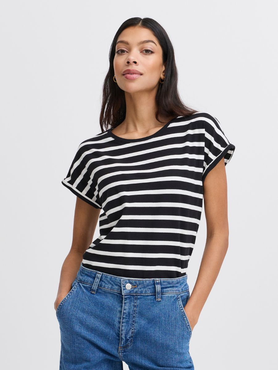 Model wearing B. Young Pamila Striped Crew Tee in black and white stripes paired with blue denim jeans by B. Young