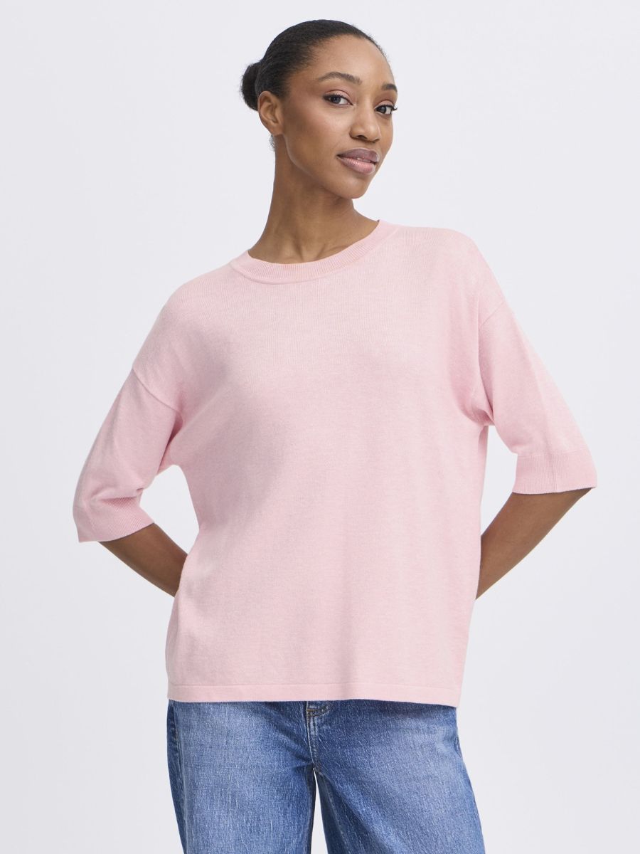 Model wearing a light pink B. Young Morla Short Sleeve Crew Top paired with blue jeans by B. Young
