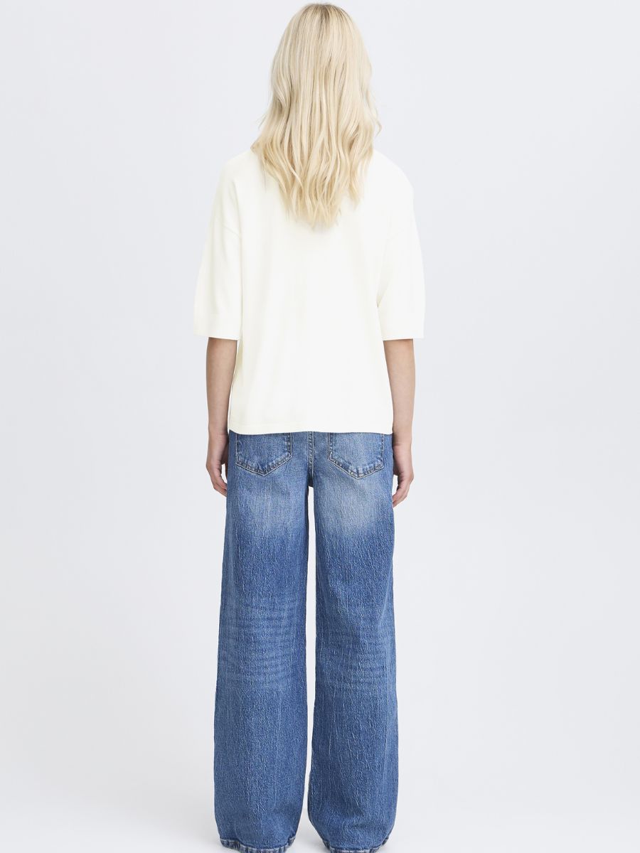 Back view of B. Young Morla Short Sleeve Crew Top in white paired with wide leg blue denim jeans by B. Young