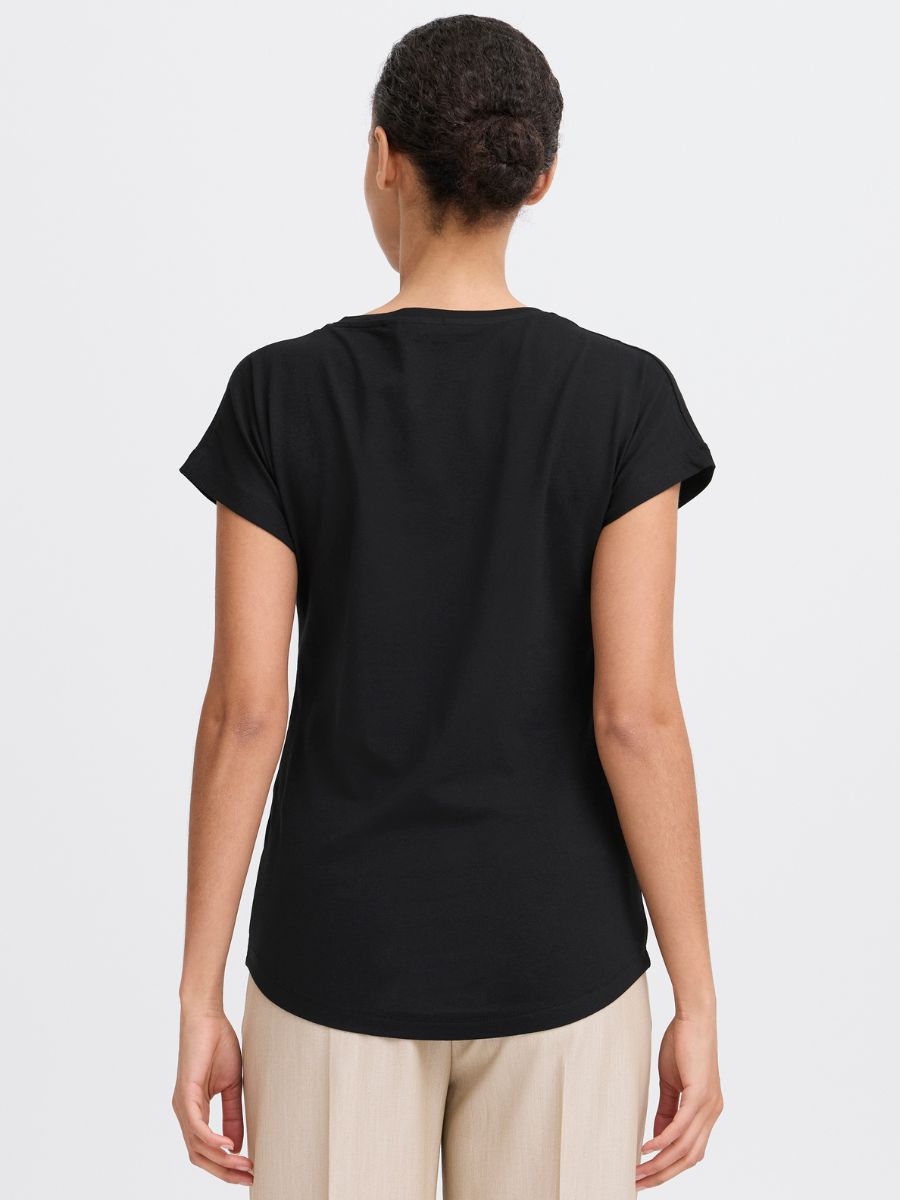 Back view of B. Young Pamila V-Neck Short Sleeve Tee in black, styled with beige pants by B. Young.
