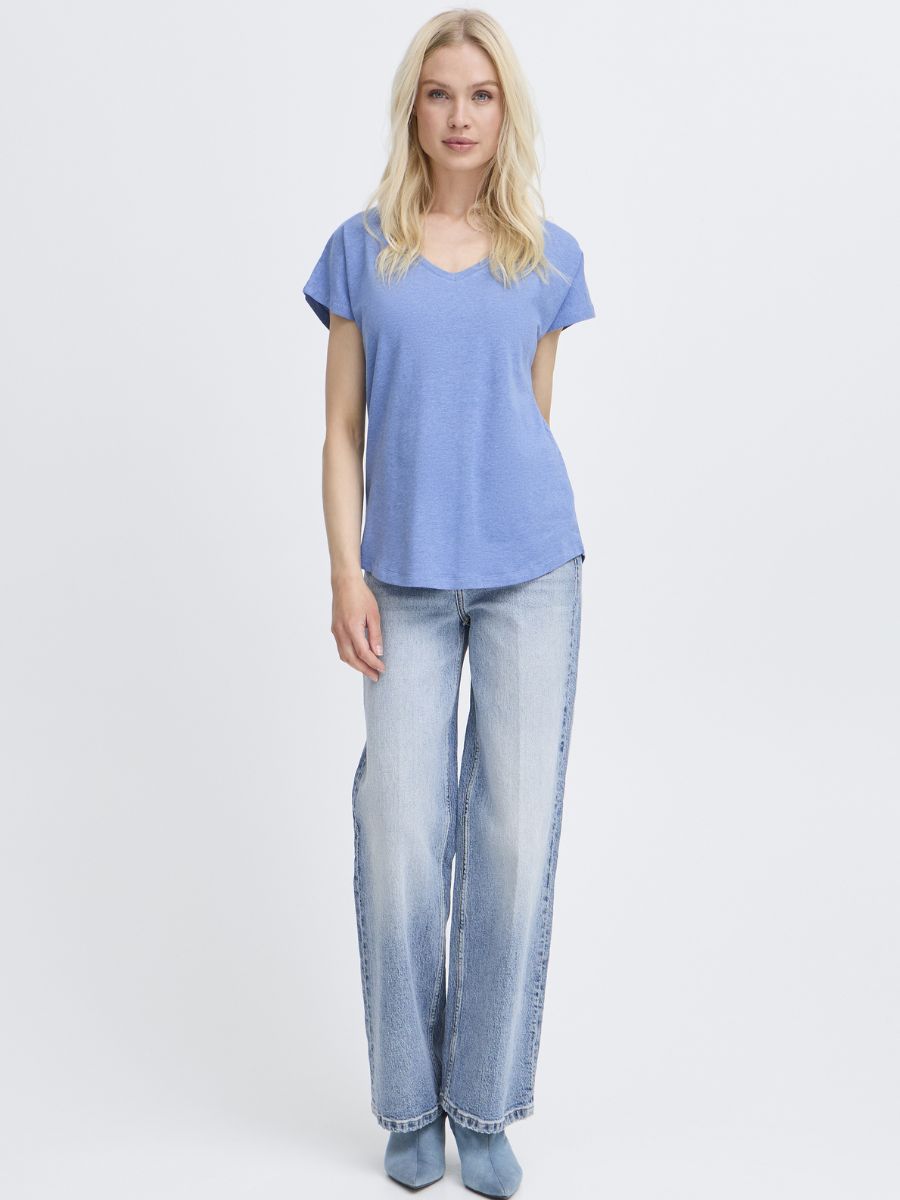 Light blue B. Young Pamila V-Neck Short Sleeve Tee styled with light wash denim jeans and blue boots.