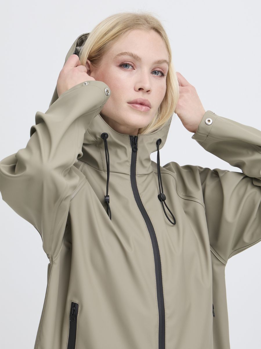 B. Young Avan Long Rain Coat in taupe with hood and zipper details, a stylish outerwear piece by B. Young.