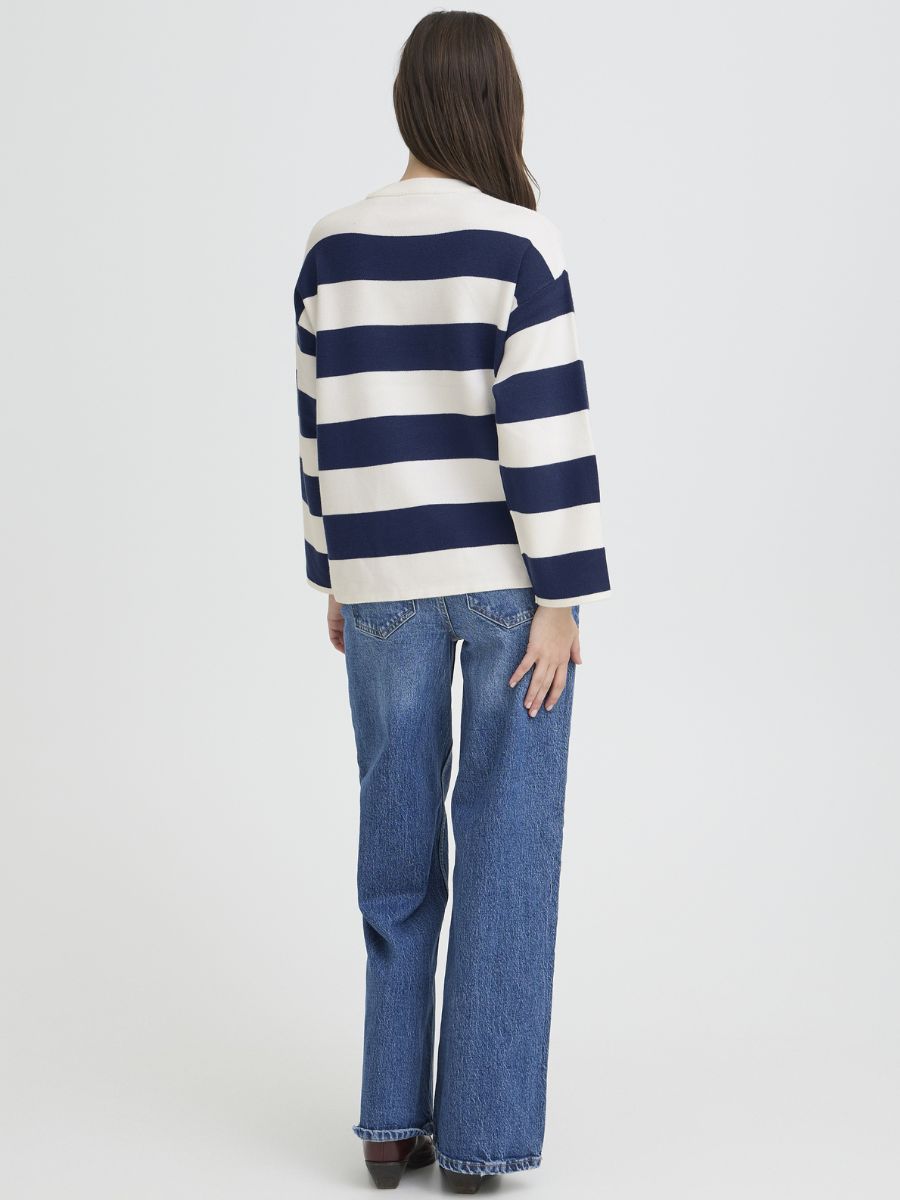 B. Young Otari Striped Sweater in navy and white stripes by B. Young, paired with blue denim jeans.