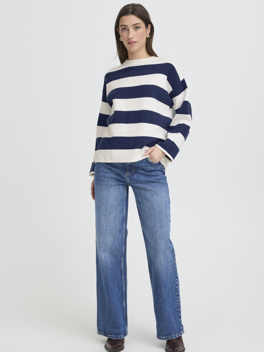 B. Young Otari Striped Sweater in navy and cream, paired with blue denim jeans, from B. Young’s sweater collection.