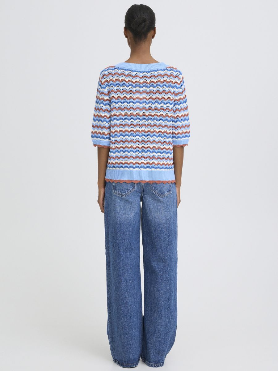 Back view of B. Young Nero V-Neck Cardigan in blue with patterned knit, styled with wide-leg denim jeans by B. Young.
