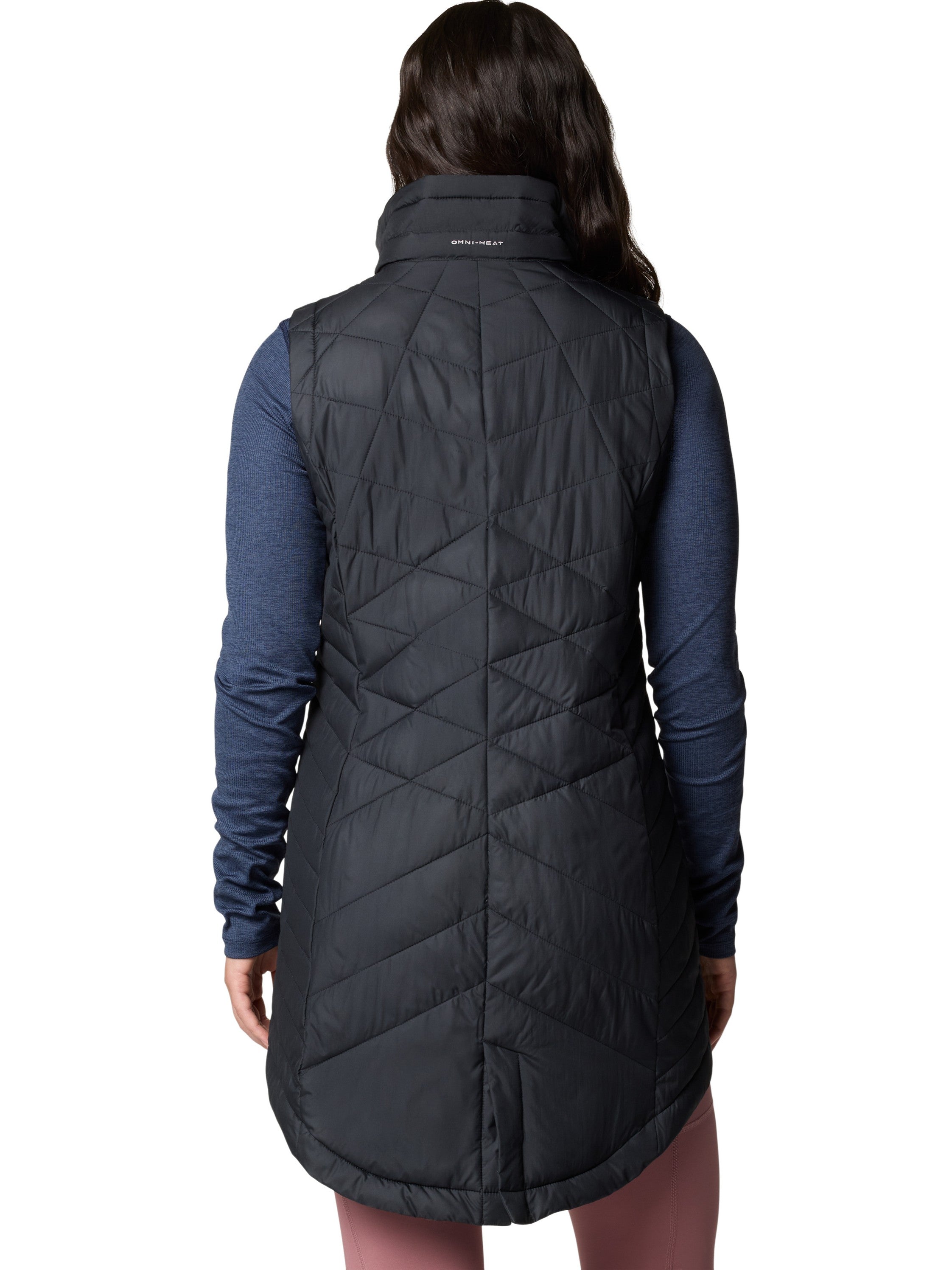 Back view of Columbia Heavenly II Omni-Heat Long Vest in black, styled as outerwear for cold weather layering.