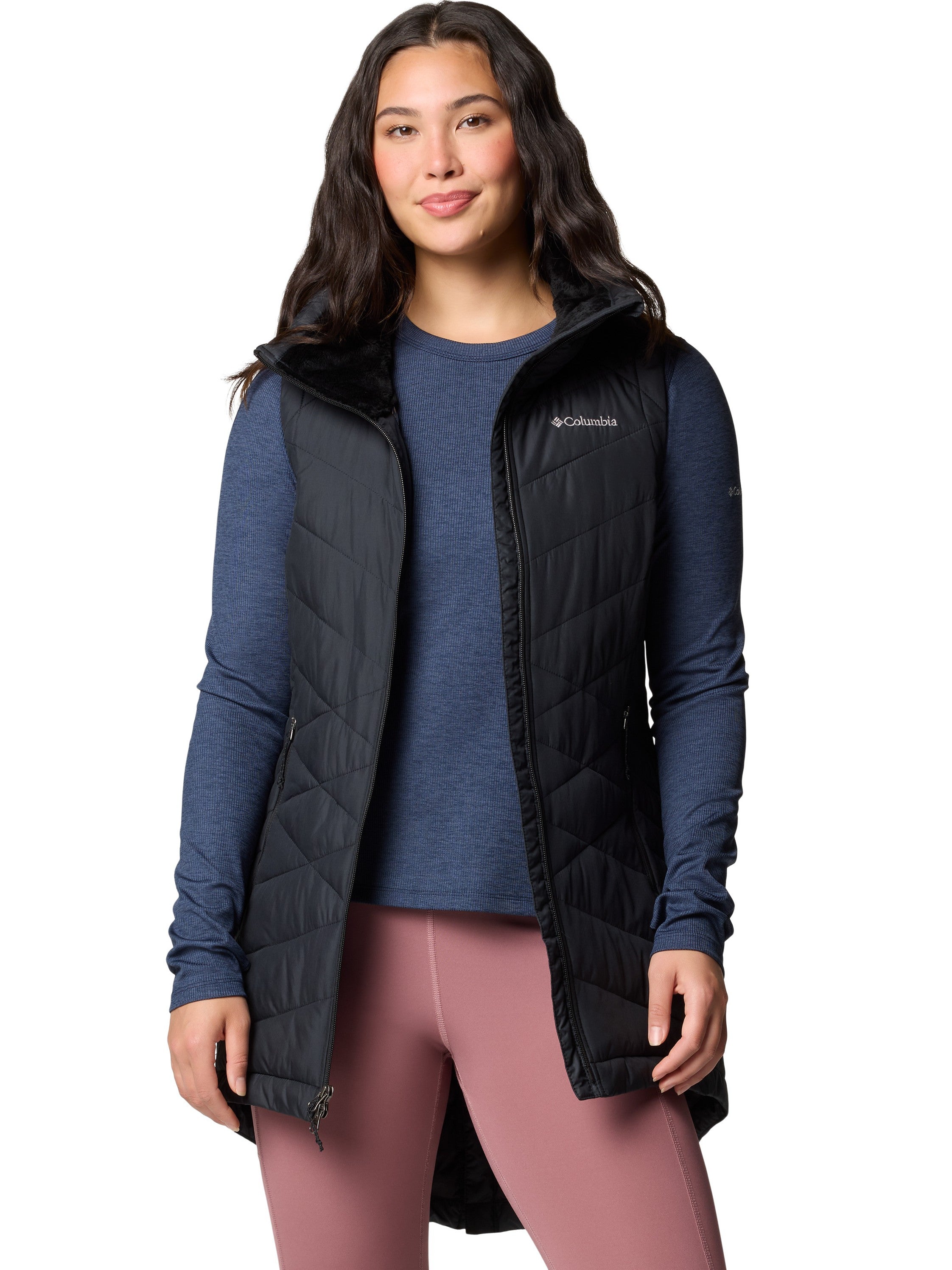 Columbia Heavenly II Omni-Heat Long Vest in black, styled over a navy long-sleeve shirt and pink leggings, outerwear by Columbia.