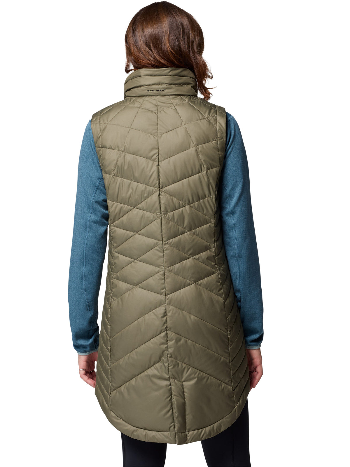 Back view of olive Columbia Heavenly II Omni-Heat Long Vest worn over a blue long-sleeve top, showcasing outerwear design.