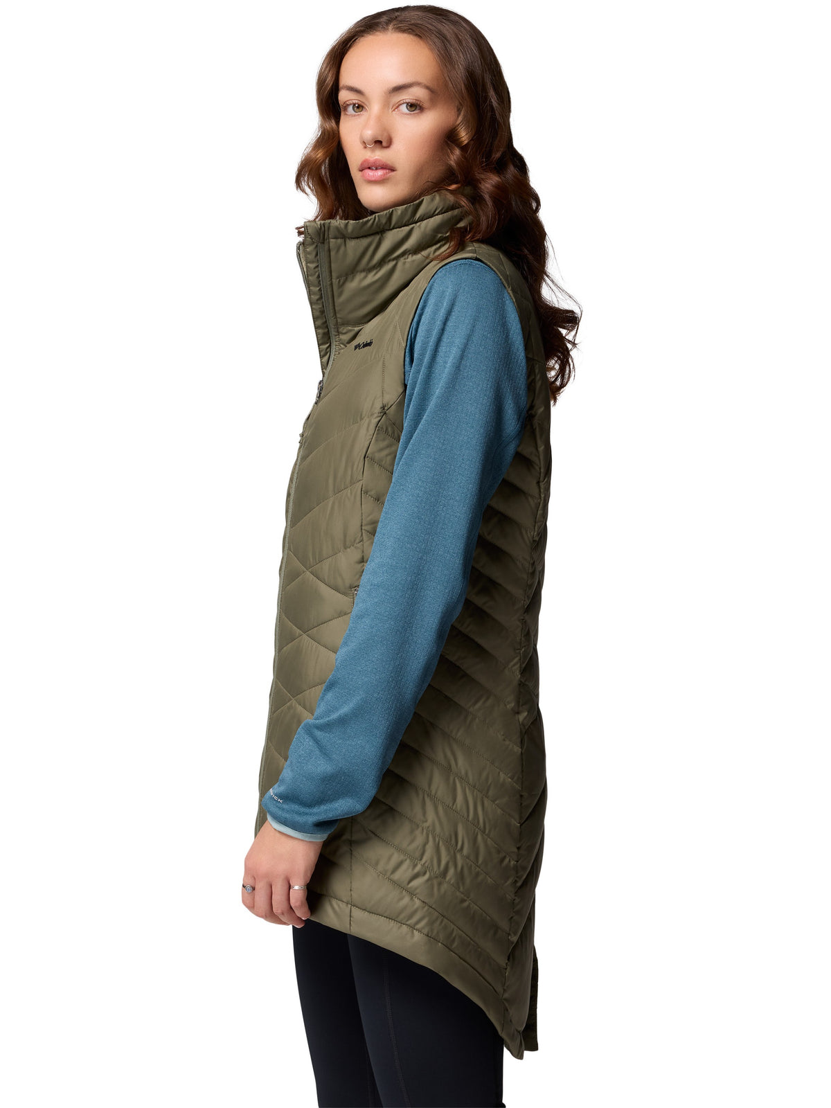 Columbia Heavenly II Omni-Heat Long Vest in olive green styled over a blue sweater, lightweight outerwear by Columbia.