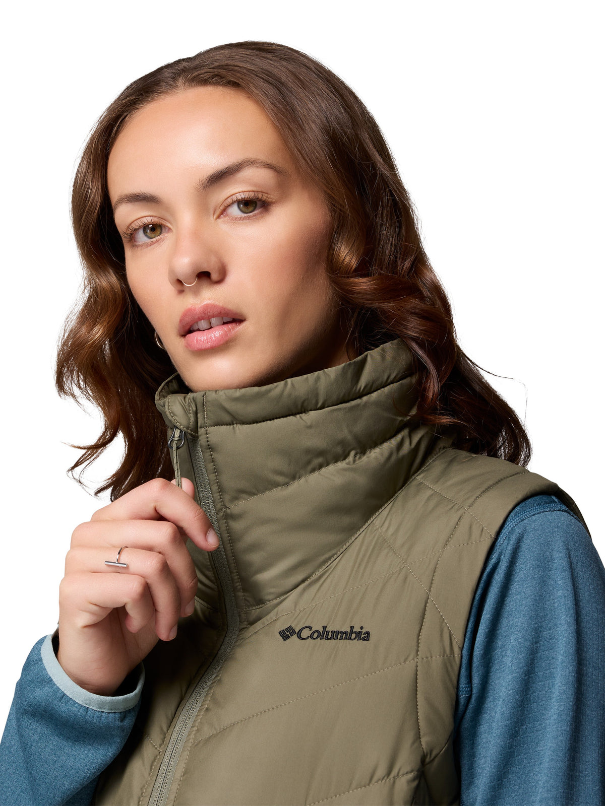 Close-up of a person wearing Columbia Heavenly II Omni-Heat Long Vest in olive green outerwear.