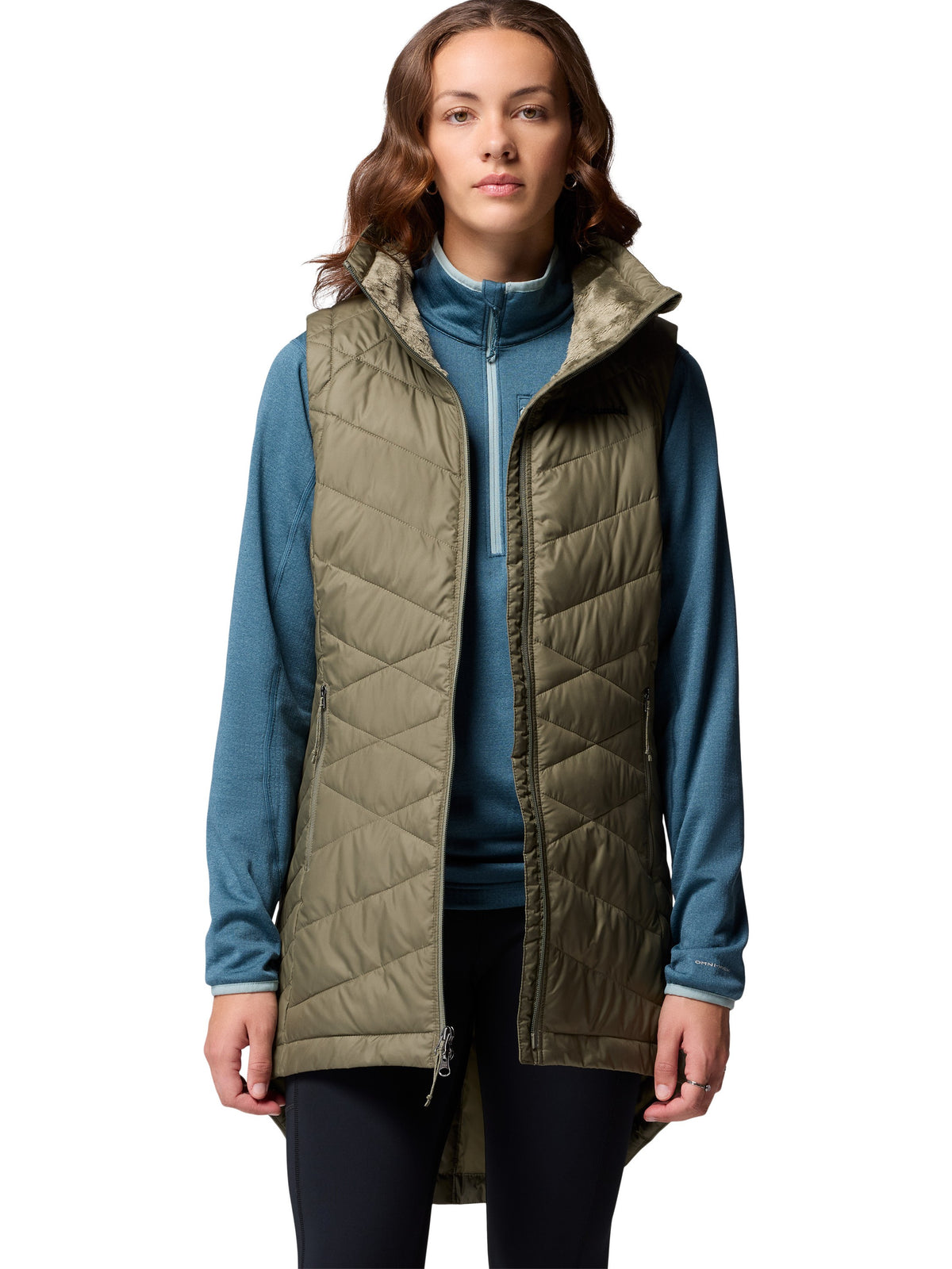 Slim fit Columbia Heavenly II Omni-Heat Long Vest in olive green layered over a blue zip-up jacket, outdoors style outerwear