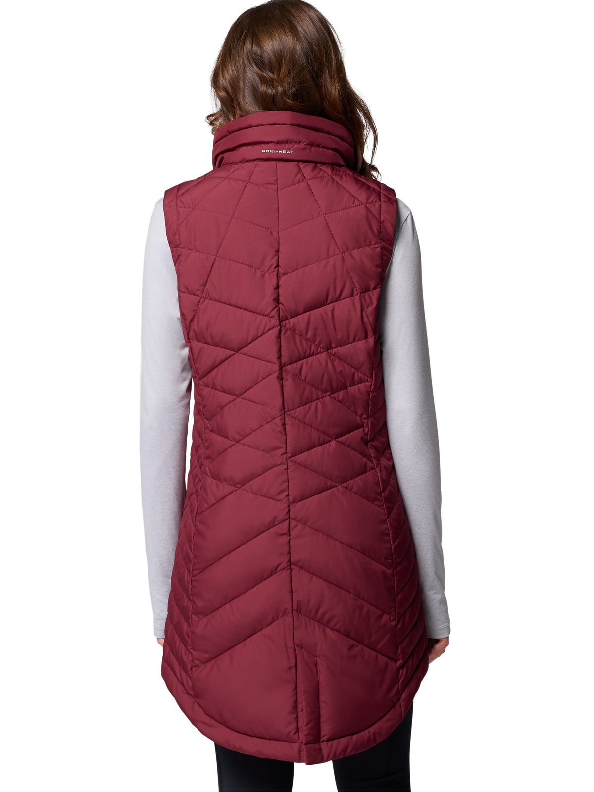 Back view of Columbia Heavenly II Omni-Heat Long Vest in wine color, styled over a white long sleeve top.