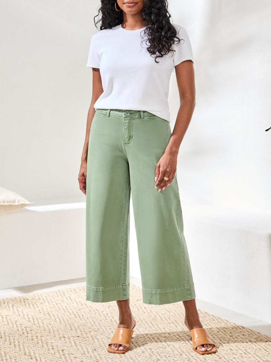 Light green wide-leg denim pants styled with a white top and tan sandals featuring Tribal Comfort Fit 26" Palazzo Denim Pants by Tribal Sportswear Inc.