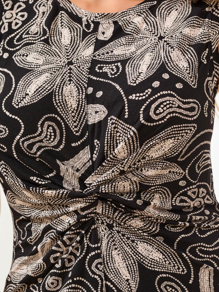 Close-up of black Tribal Twisted Print Sleeveless Dress with beige floral patterns by Tribal Sportswear Inc.