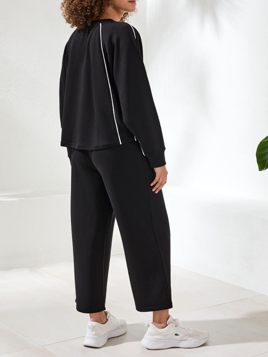 Tribal Techno Lux Piping Scuba Crew Top by Tribal Sportswear Inc. in black with white piping detail on sleeves and back