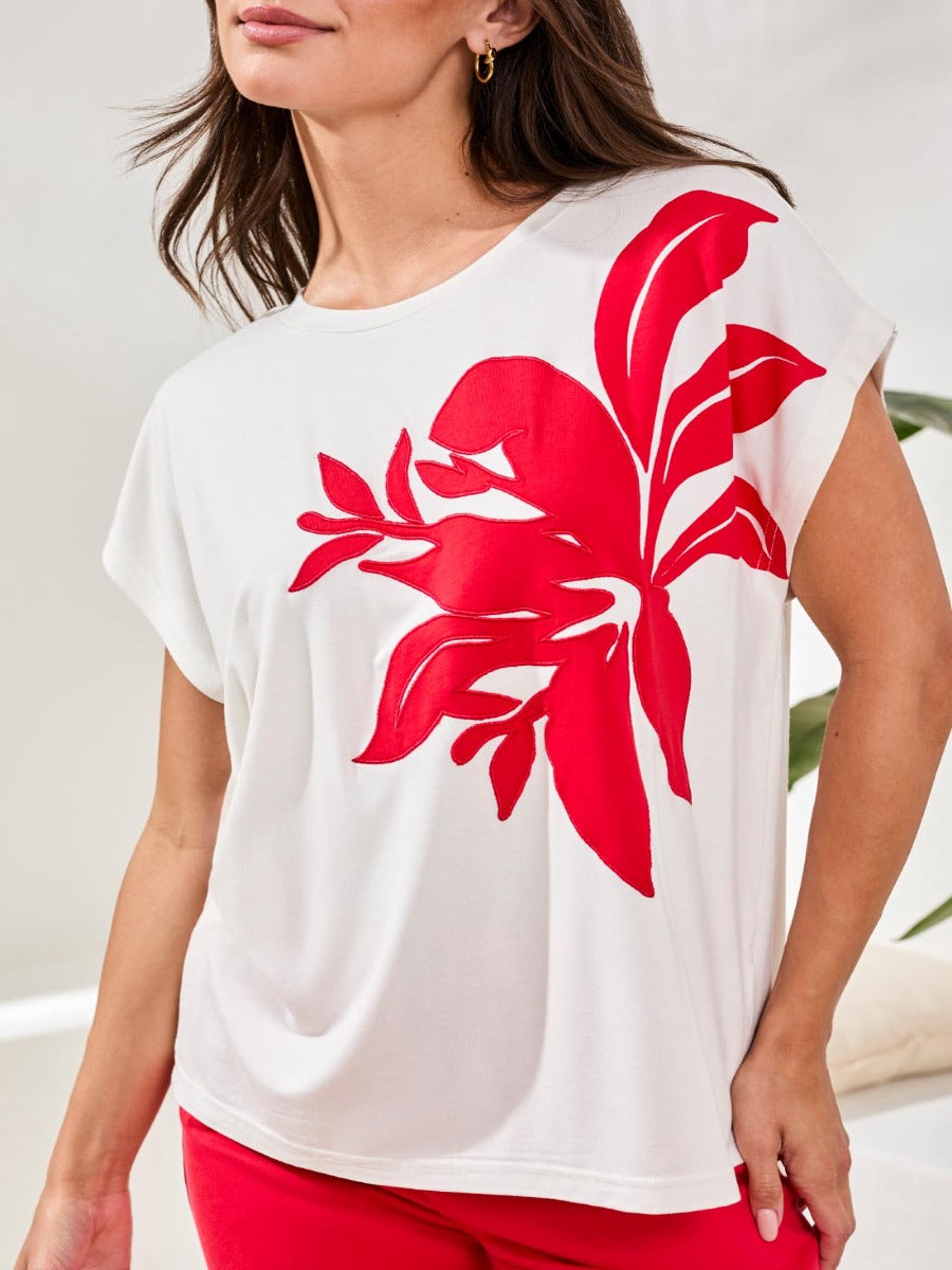 Tribal Playful Applique Short-Sleeve Top in white with bold red floral applique by Tribal Sportswear Inc.