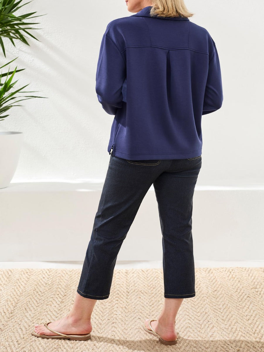 Rear view of a navy top paired with dark cropped jeans and sandals in bright natural light by Tribal Sportswear Inc. Tribal Techno Lux Playful V-Neck Top