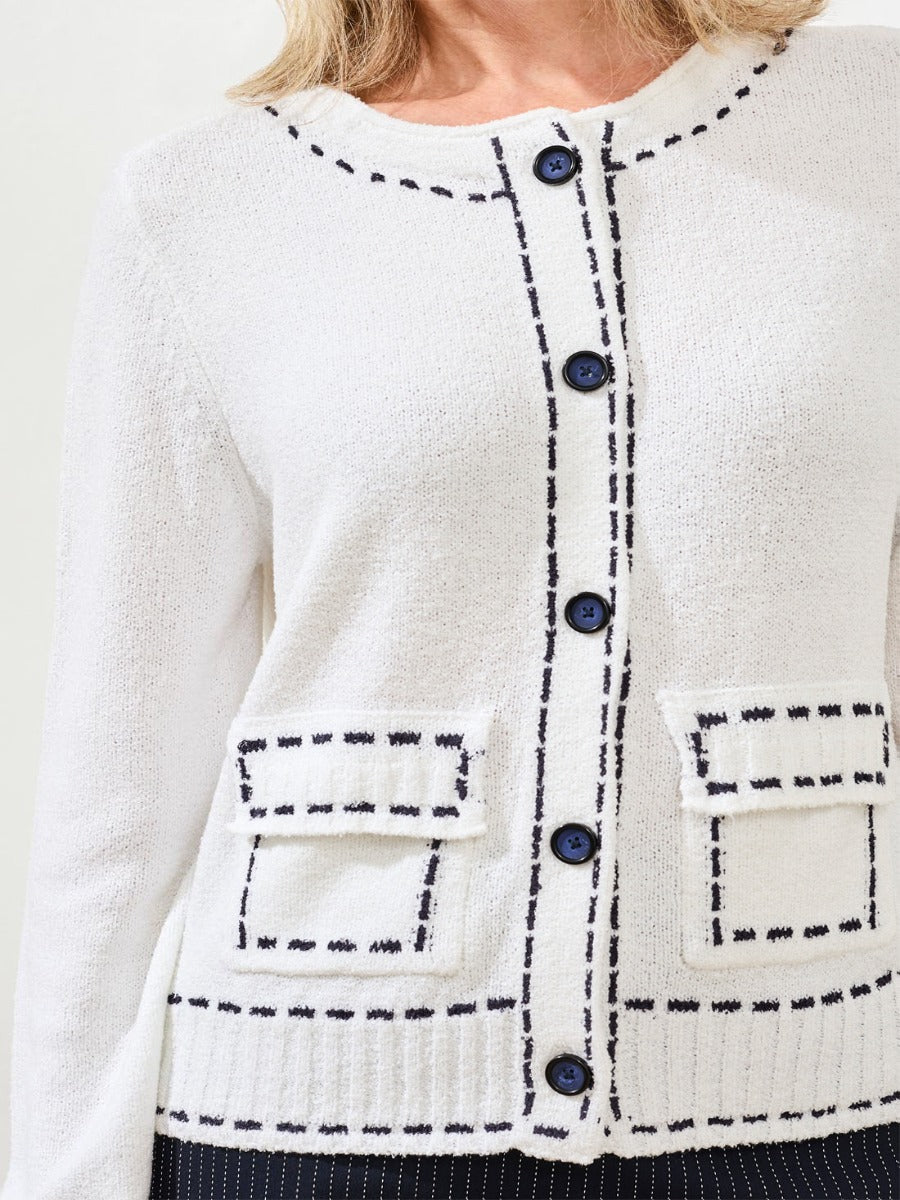 Close-up of a white Tribal Playful Stitch Pocket Crew Cardigan with black stitching and blue buttons by Tribal Sportswear Inc.