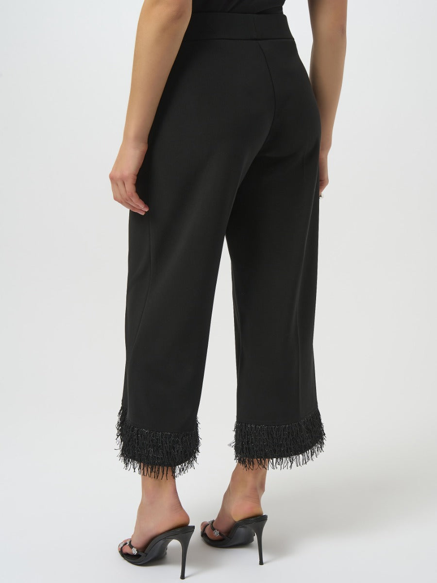 Rear view of black Joseph Ribkoff High-Waisted Fringe Trousers with fringed hems and high heels
