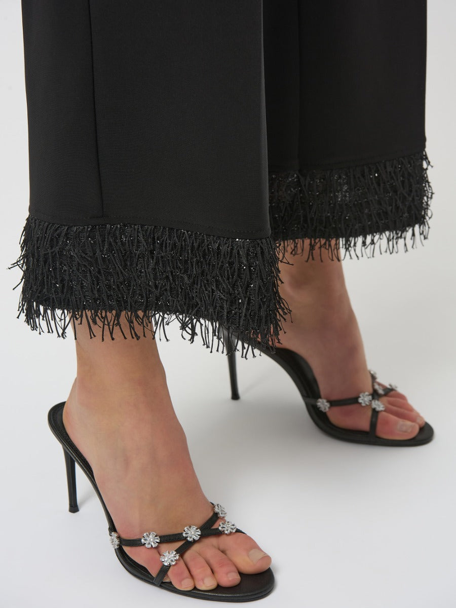 Close-up of Joseph Ribkoff High-Waisted Fringe Trousers in black with embellished black heeled sandals.