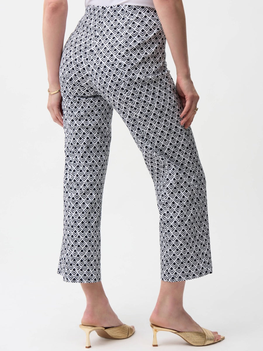 Back view of cropped pants with black and white geometric pattern paired with beige heeled sandals