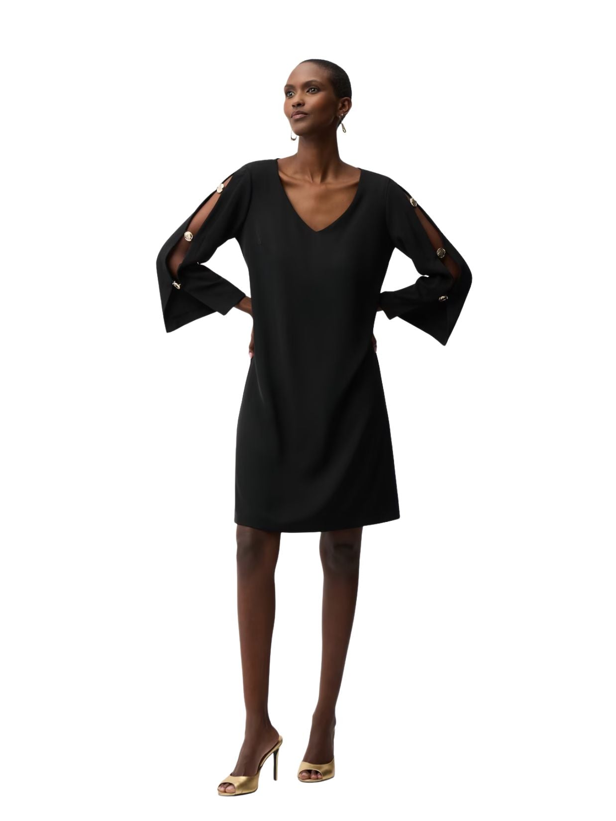 Model wearing a black V-neck dress with open slit sleeves featuring decorative buttons and gold high-heeled shoes.