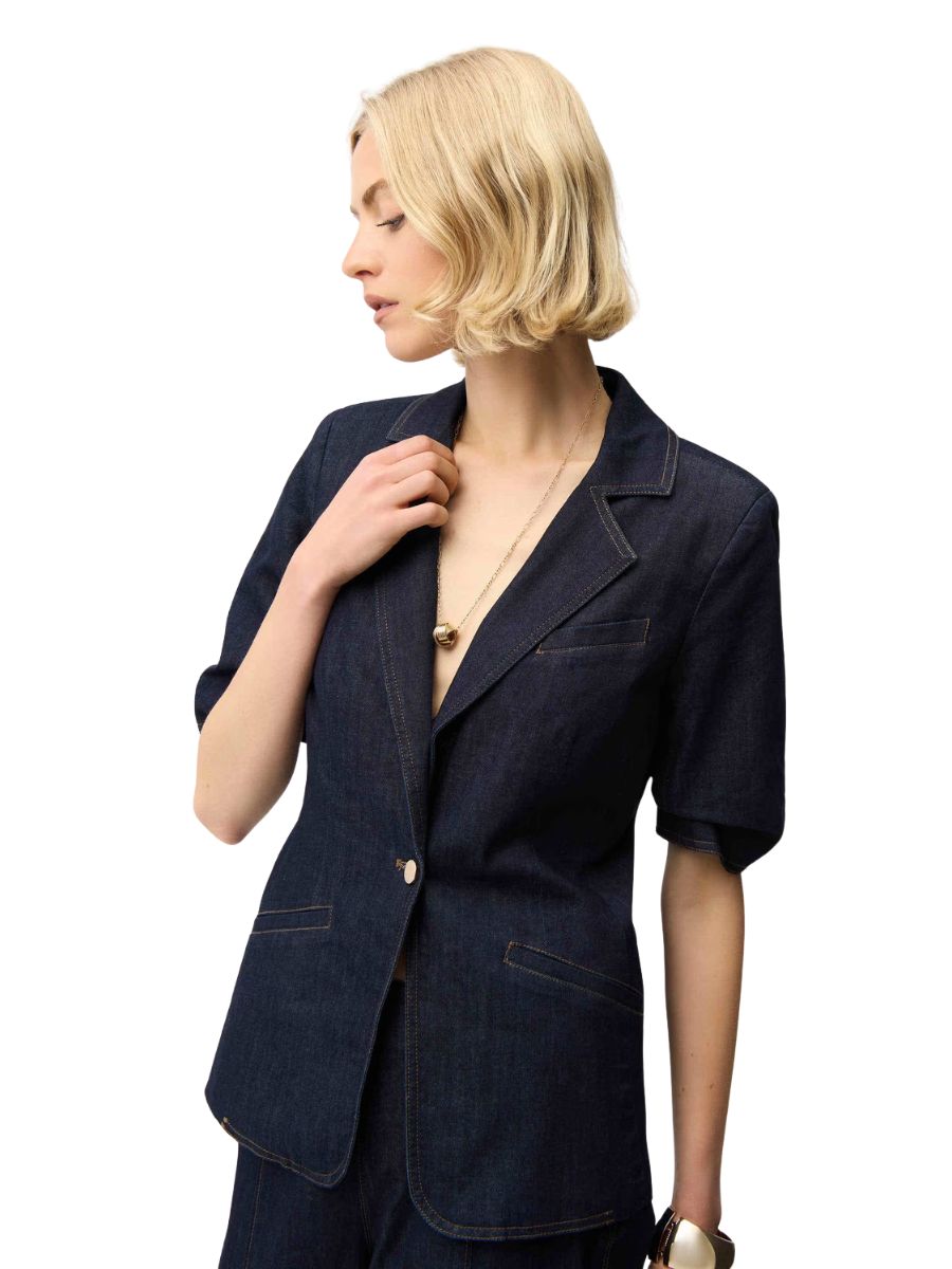 Joseph Ribkoff Playful Denim Stitch Short Sleeve Blazer in dark denim with detailed stitching, paired with a gold necklace.