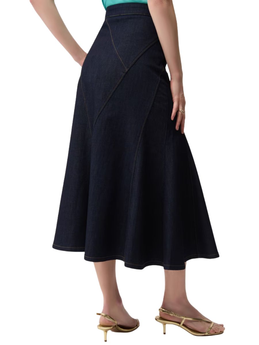 Dark denim midi skirt with panel detailing styled with gold strappy heels against a plain background
