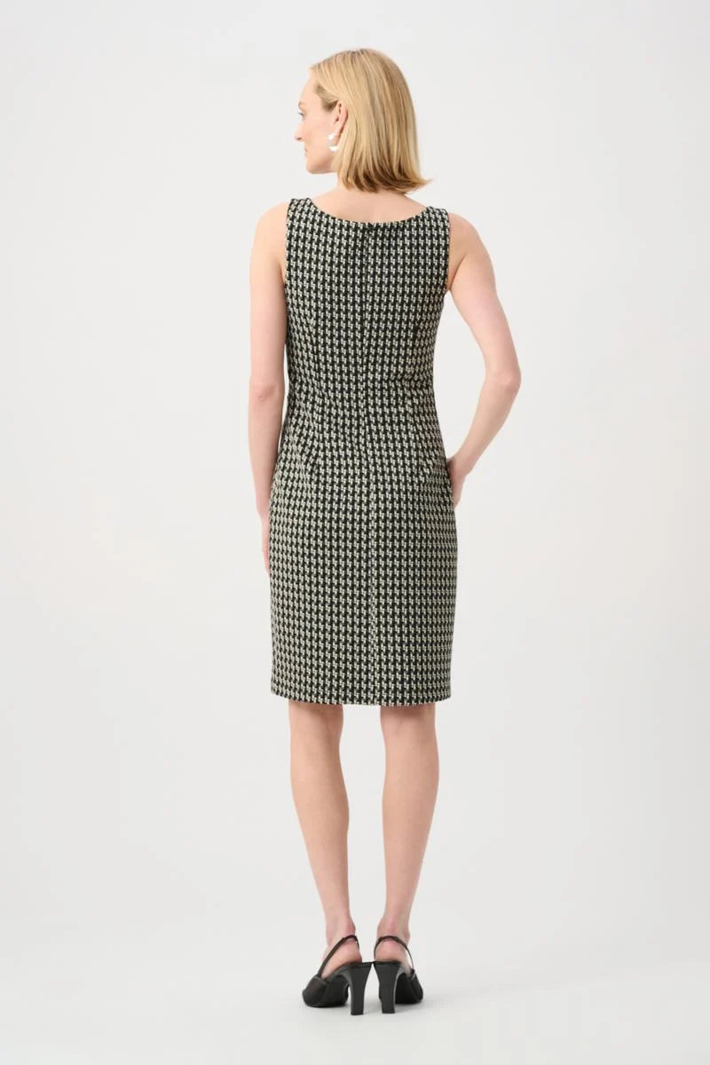Back view of a sleeveless knee-length houndstooth patterned dress paired with black heeled shoes.