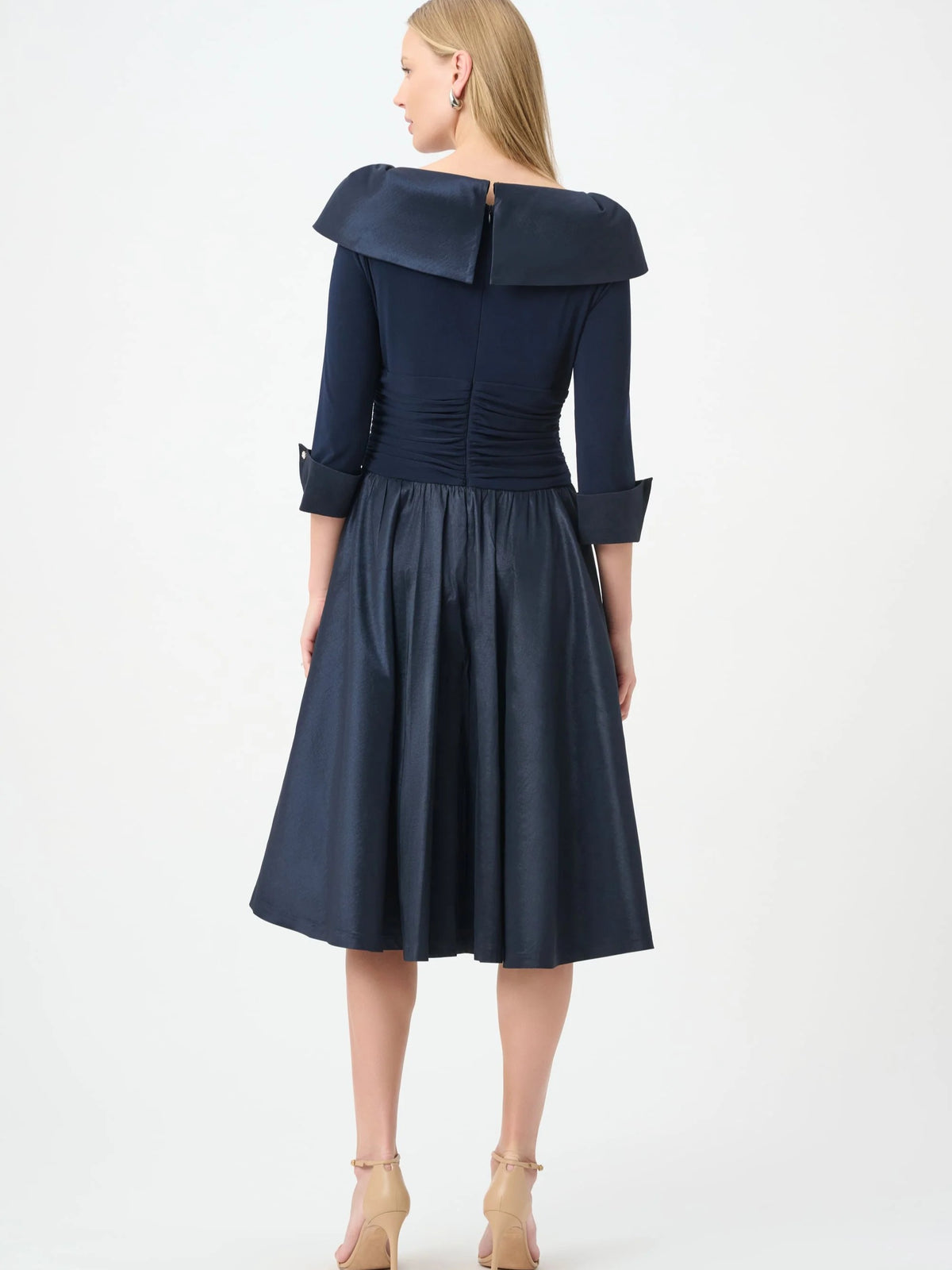 Back view of a navy blue dress with three-quarter sleeves, wide collar, and a gathered waistline.