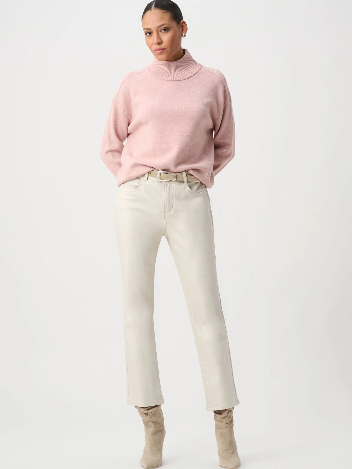 Light pink turtleneck sweater paired with off-white straight-leg jeans and beige ankle boots.