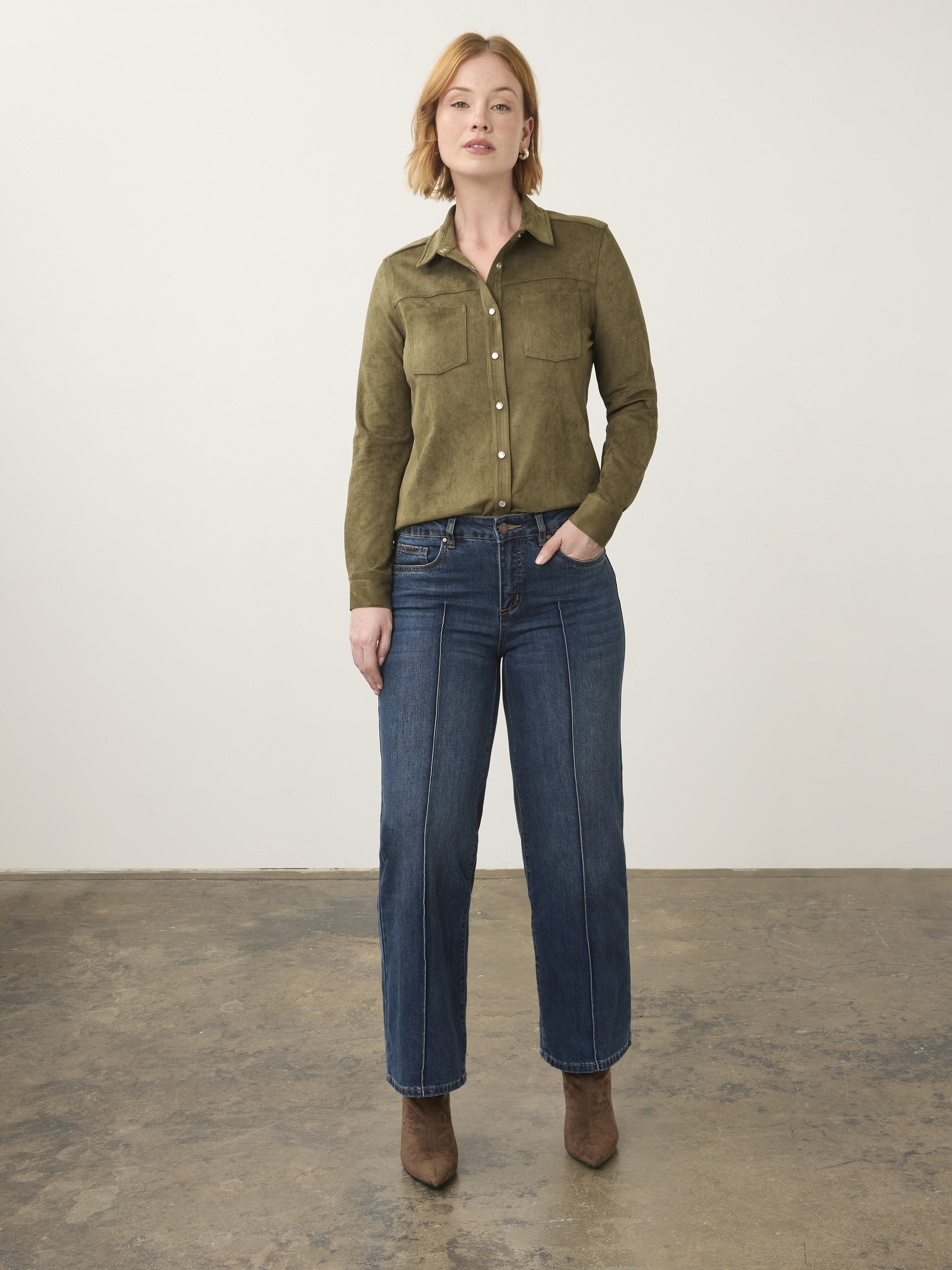 Olive green button-up top with chest pockets paired with dark blue denim jeans and brown ankle boots.