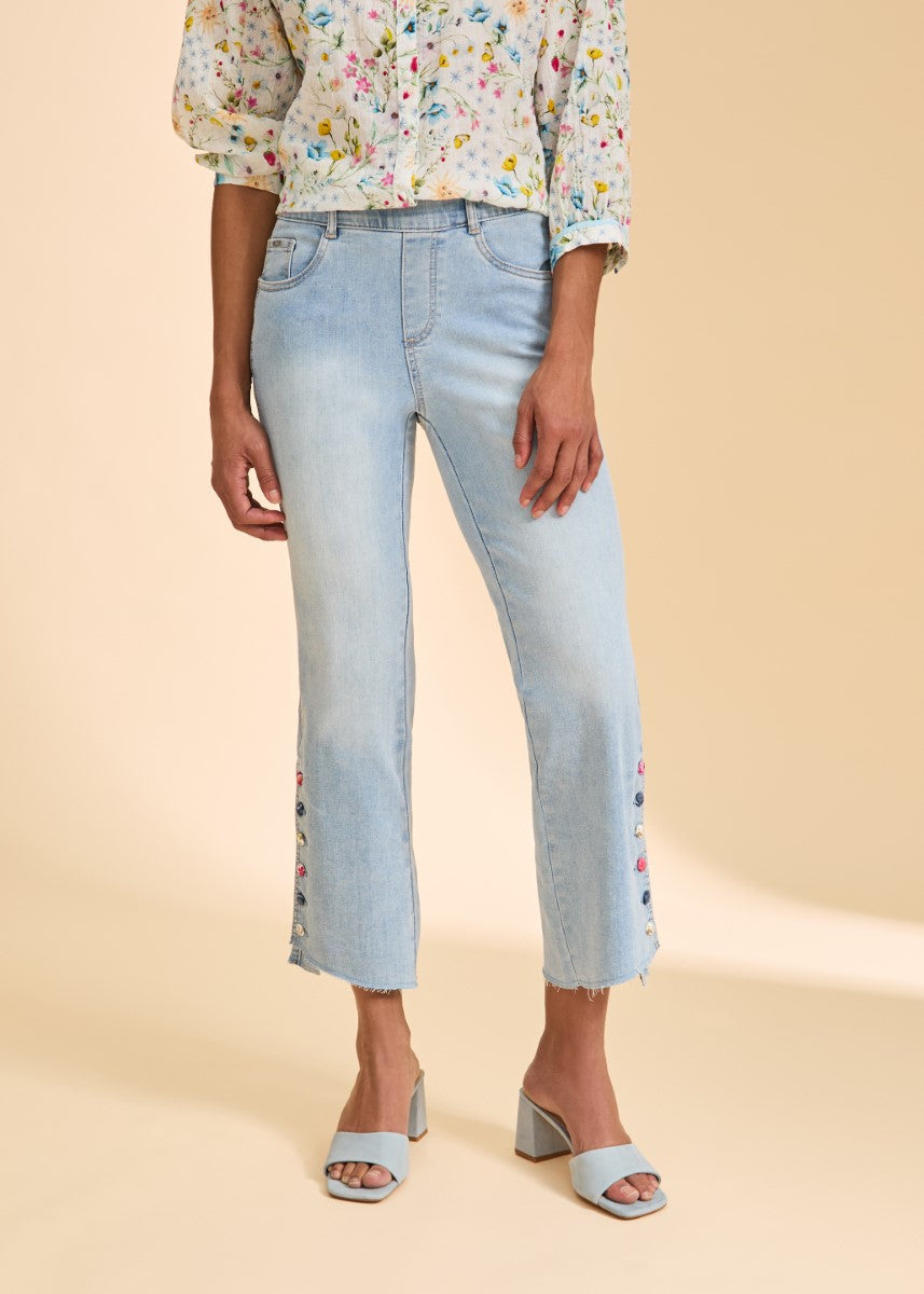 Light wash denim with floral embroidery on cropped legs, styled with a floral blouse and light blue heels, FDJ Statement 26” Denim Pant by French Dressing.