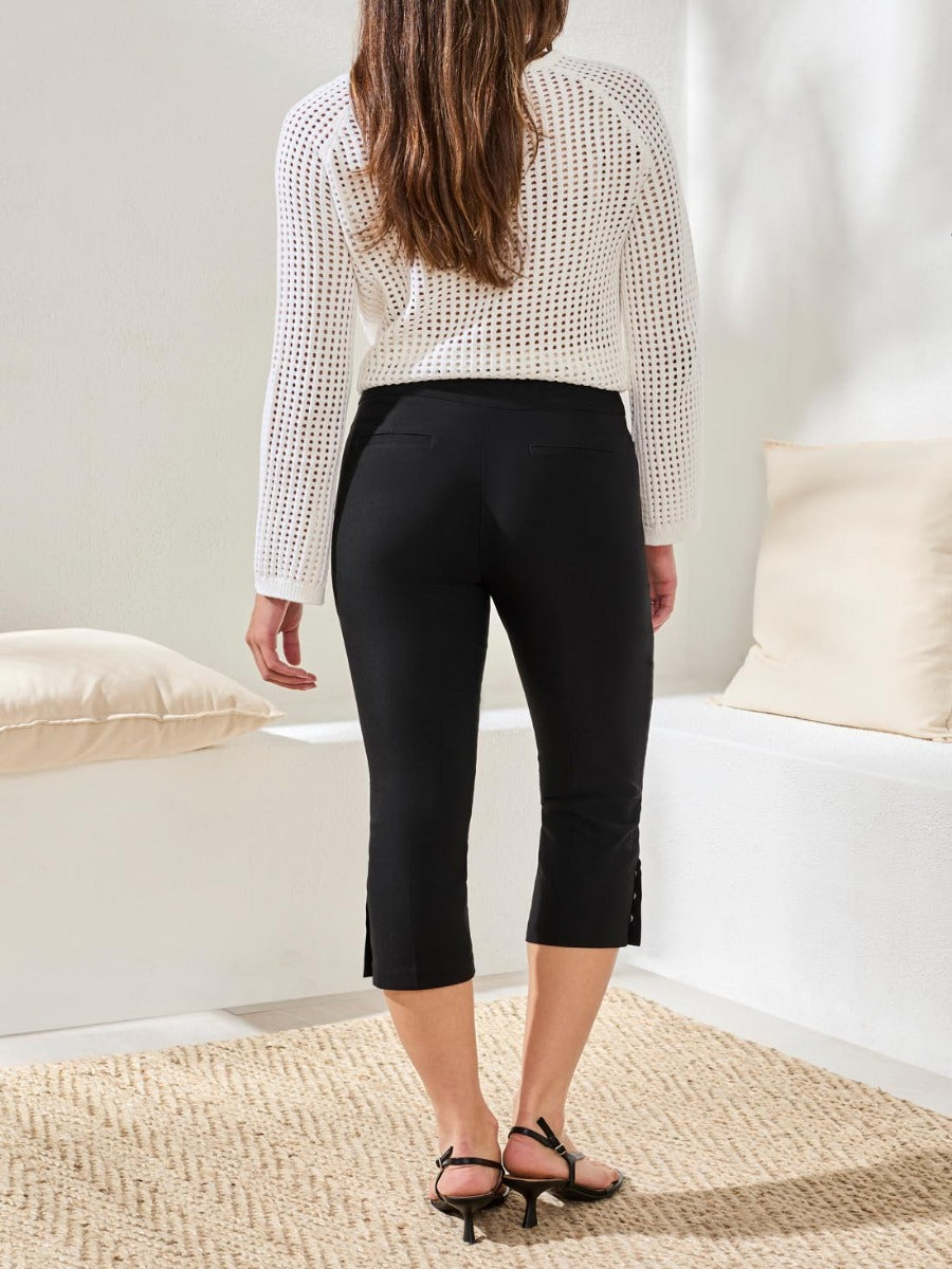 Black cropped capri pants with side snaps, styled with a white knit top, from Tribal Sportswear Inc., Tribal Flatten It Snap 22" Capri Pants
