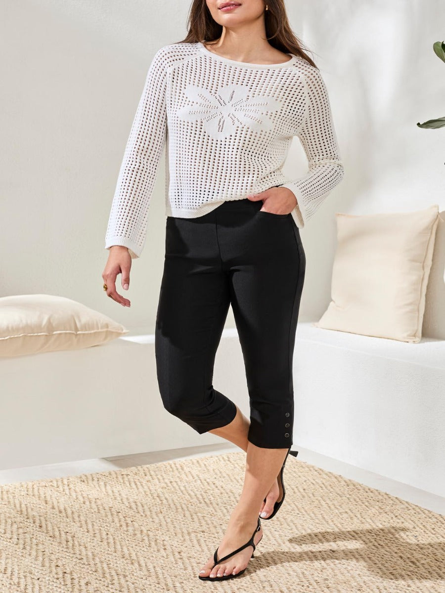 Tribal Flatten It Snap 22" Capri Pants in black by Tribal Sportswear Inc., styled with a white knit top and sandals.