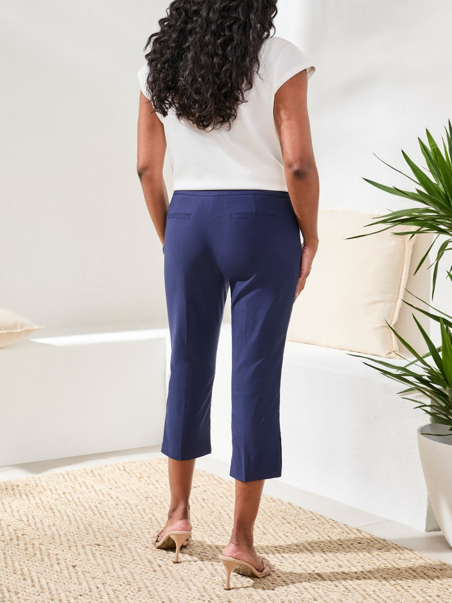 Tribal Flatten It Snap 22" Capri Pants in navy by Tribal Sportswear Inc., styled in a bright, modern living space.