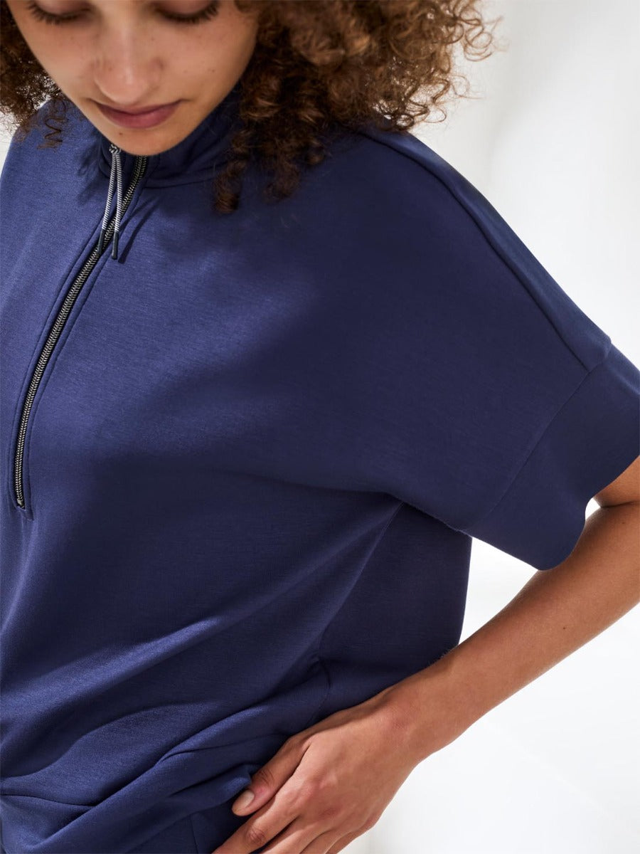 Close-up of a navy Tribal Techno 6 Lux ¼ Zip Scuba Top by Tribal Sportswear Inc. made for casual outerwear.