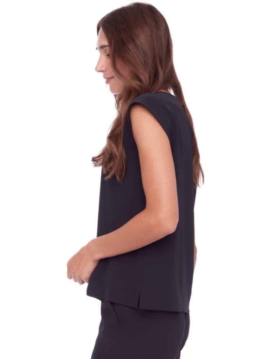 Side view of sleeveless black top with slight slit detail near hem against white background