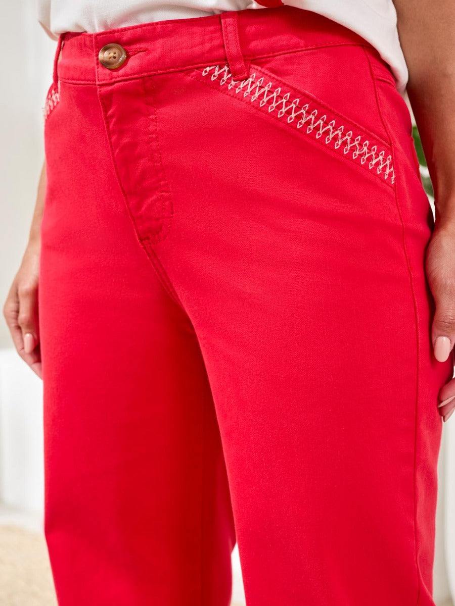 Close-up of bright red Tribal Playful Embroidered Pocket Zip 28? Pants by Tribal Sportswear Inc. showing pocket embroidery.
