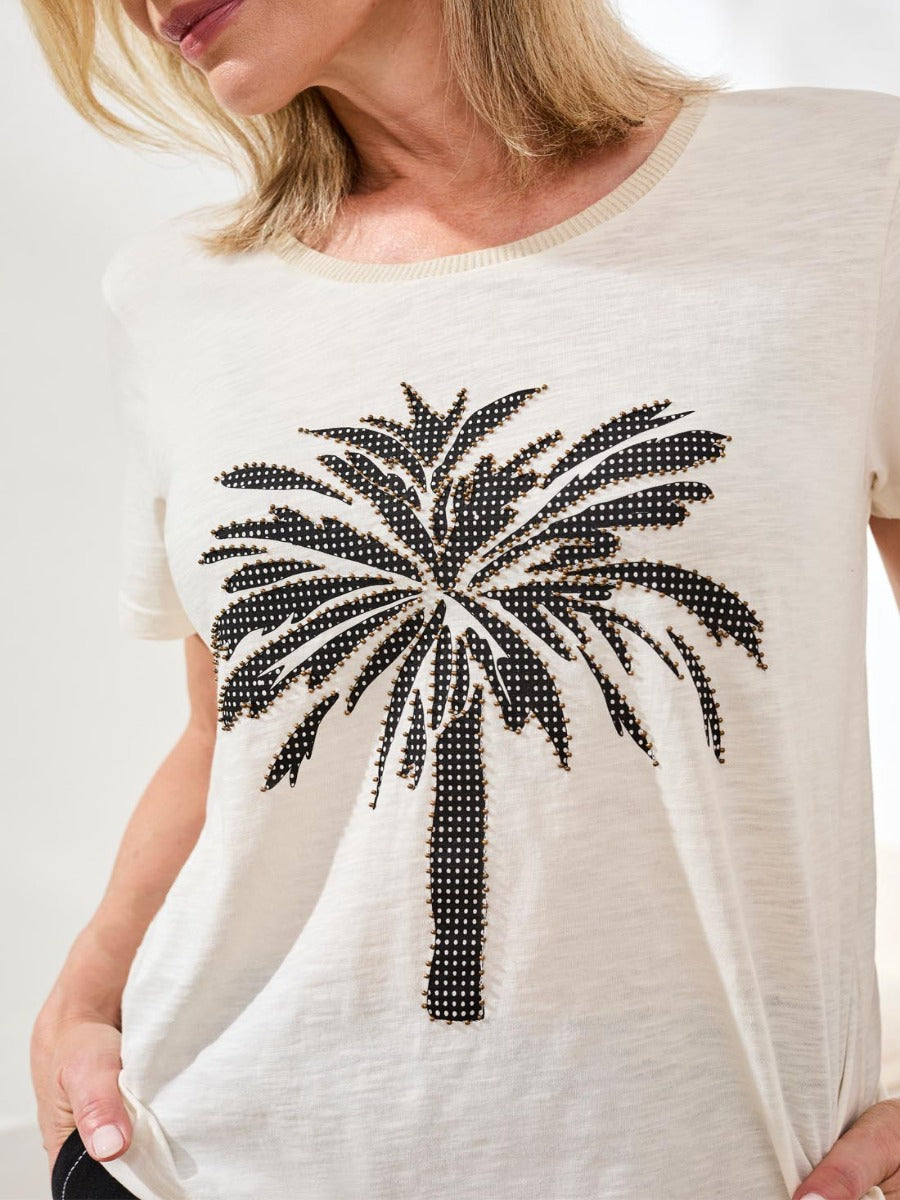 Tribal Fleur Desert Embroidered Palm Tee by Tribal Sportswear Inc. in beige with black embellished palm design.