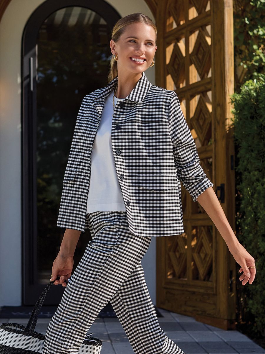 Smiling model outside in black and white gingham pants and Tribal Prep N Petals Gingham Button Jacket by Tribal Sportswear Inc.